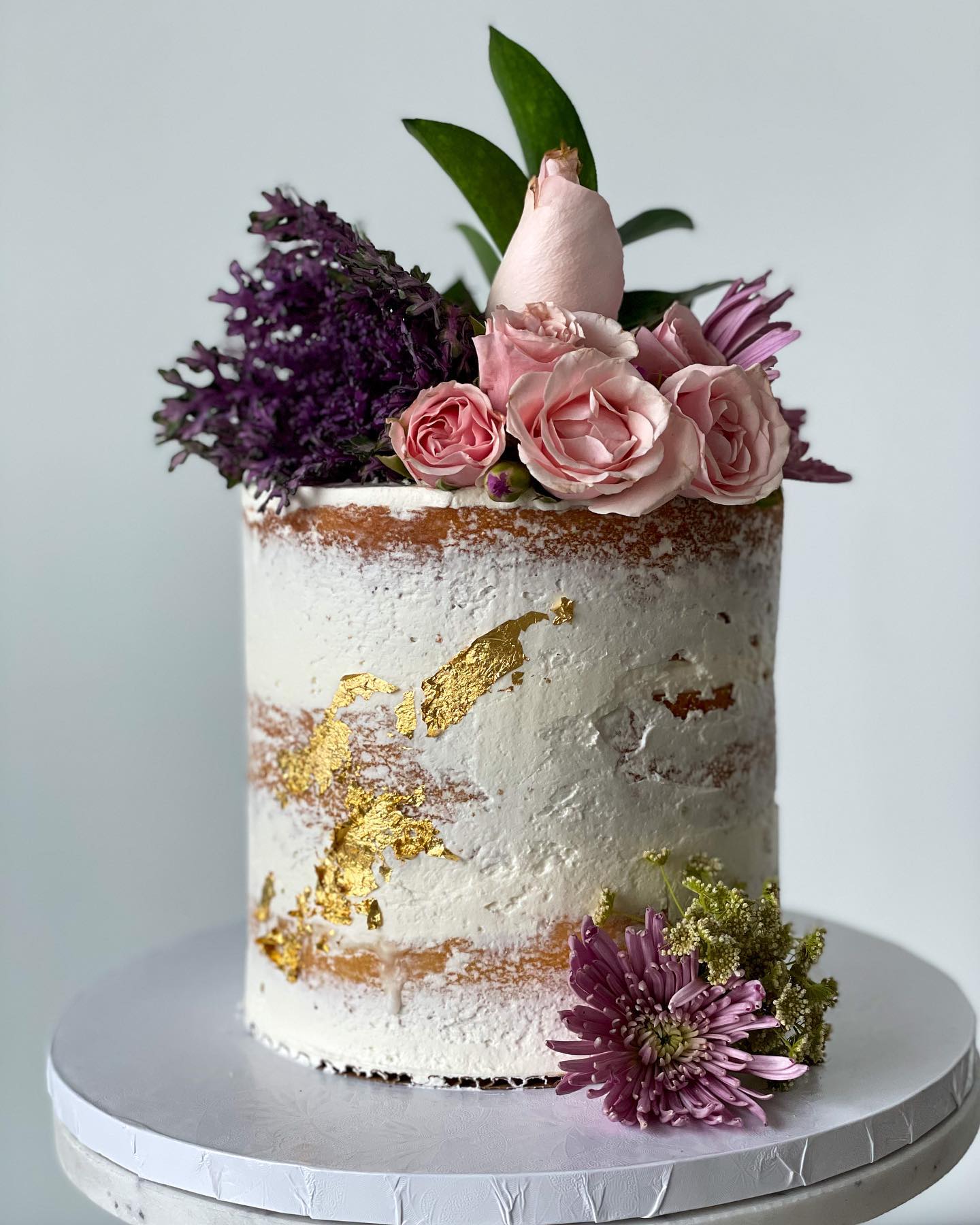 Naked cake with gold leaf and pink garden roses